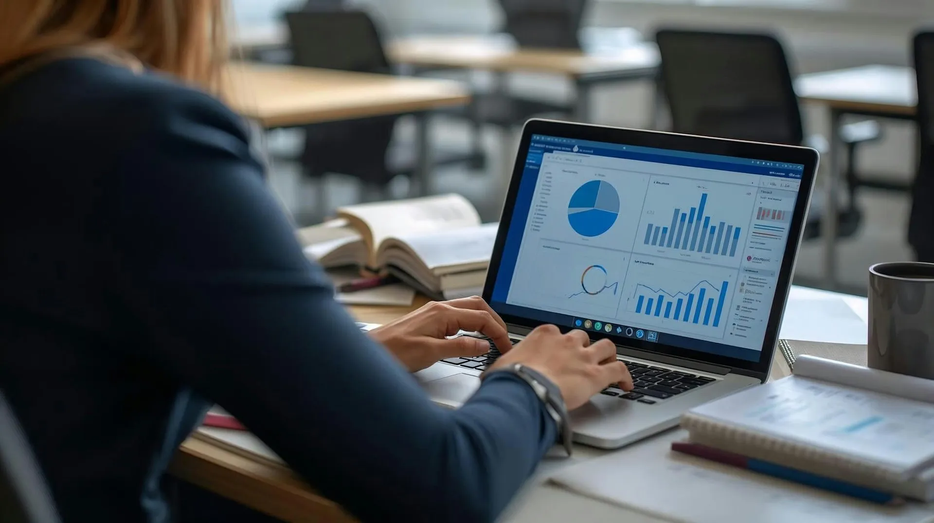 Professional analysing sales data and performance charts on a laptop