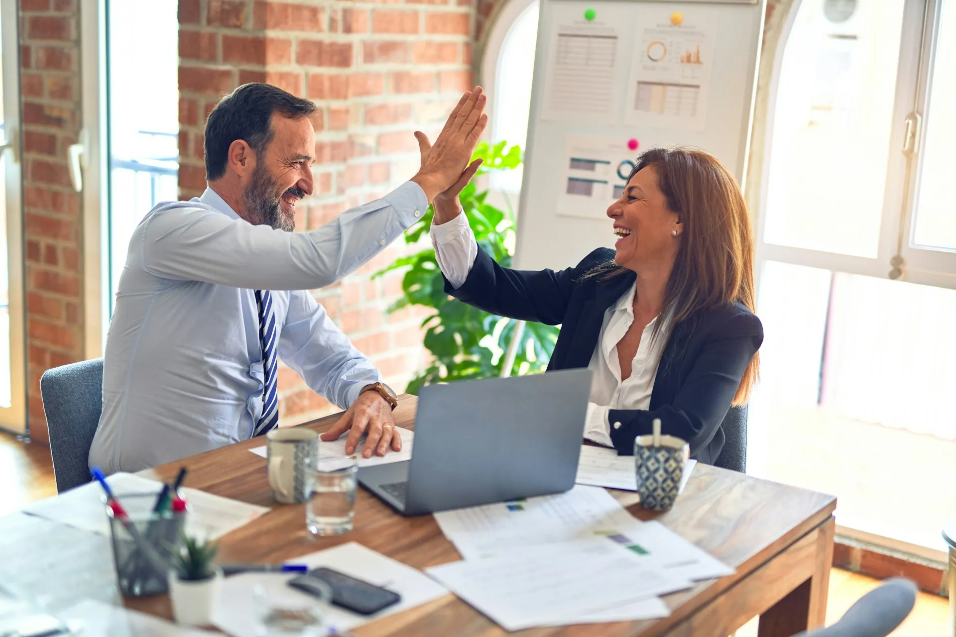Business professionals celebrating a successful sales result