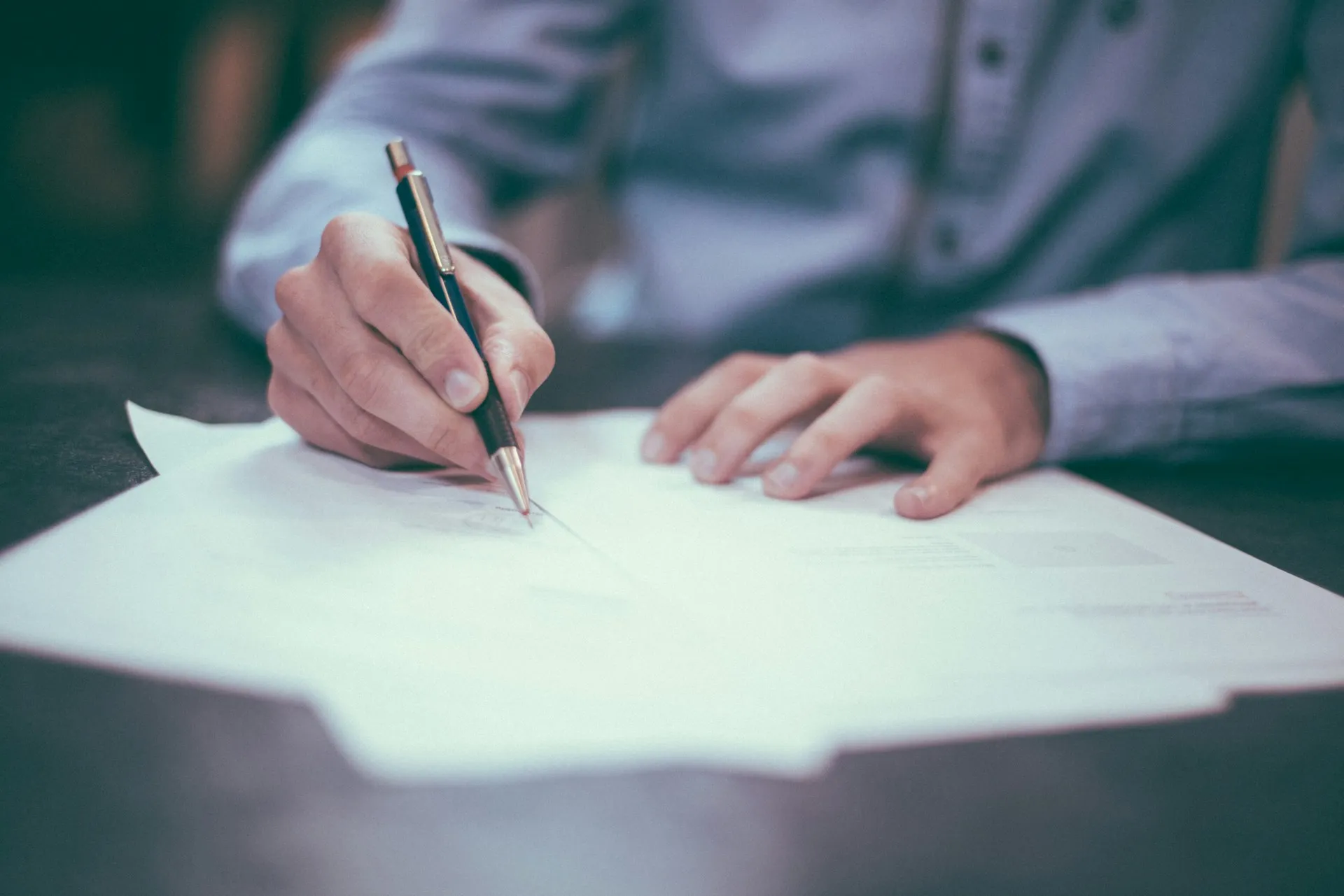 A man signing a contract