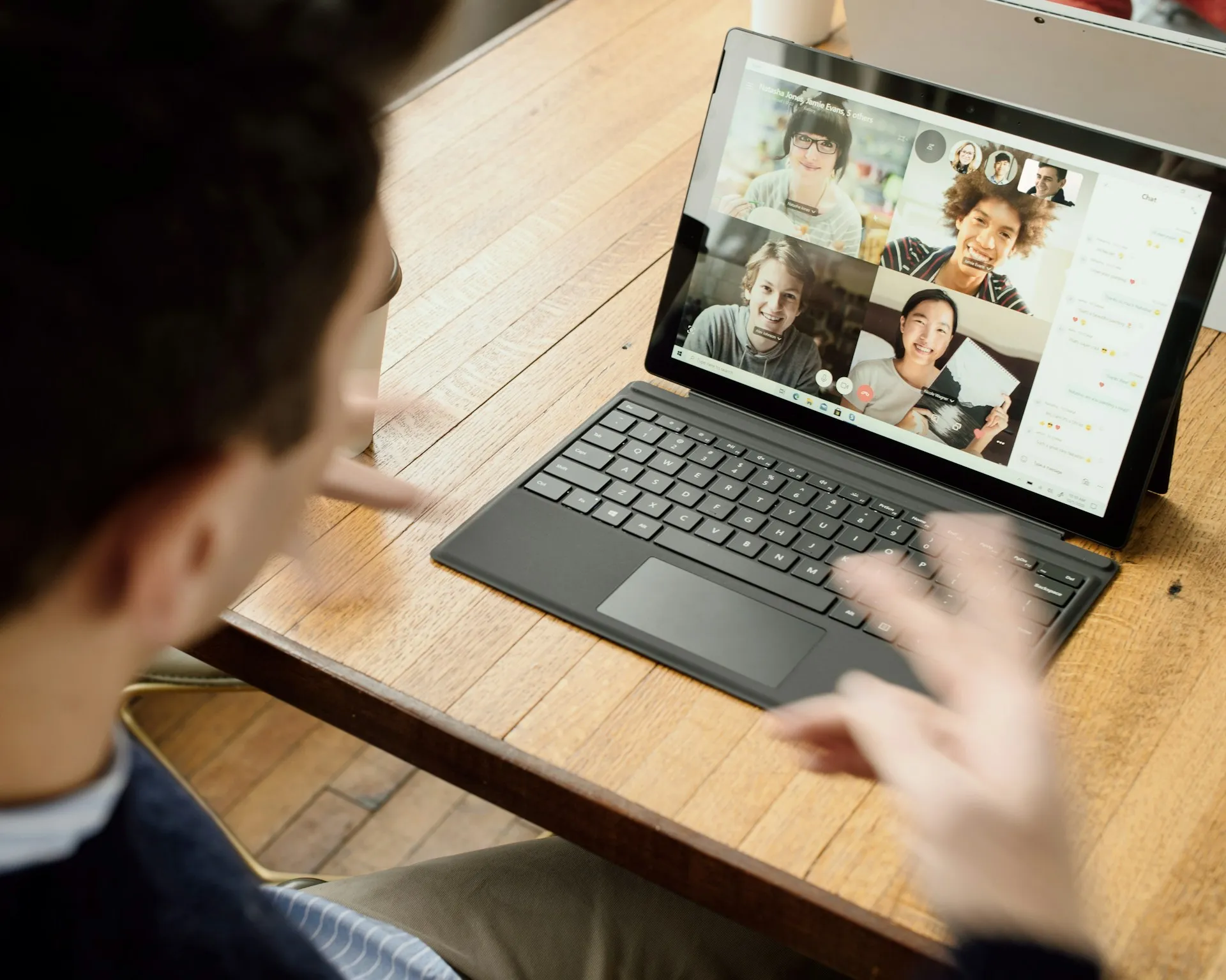 Remote team connecting through an online video meeting on a laptop