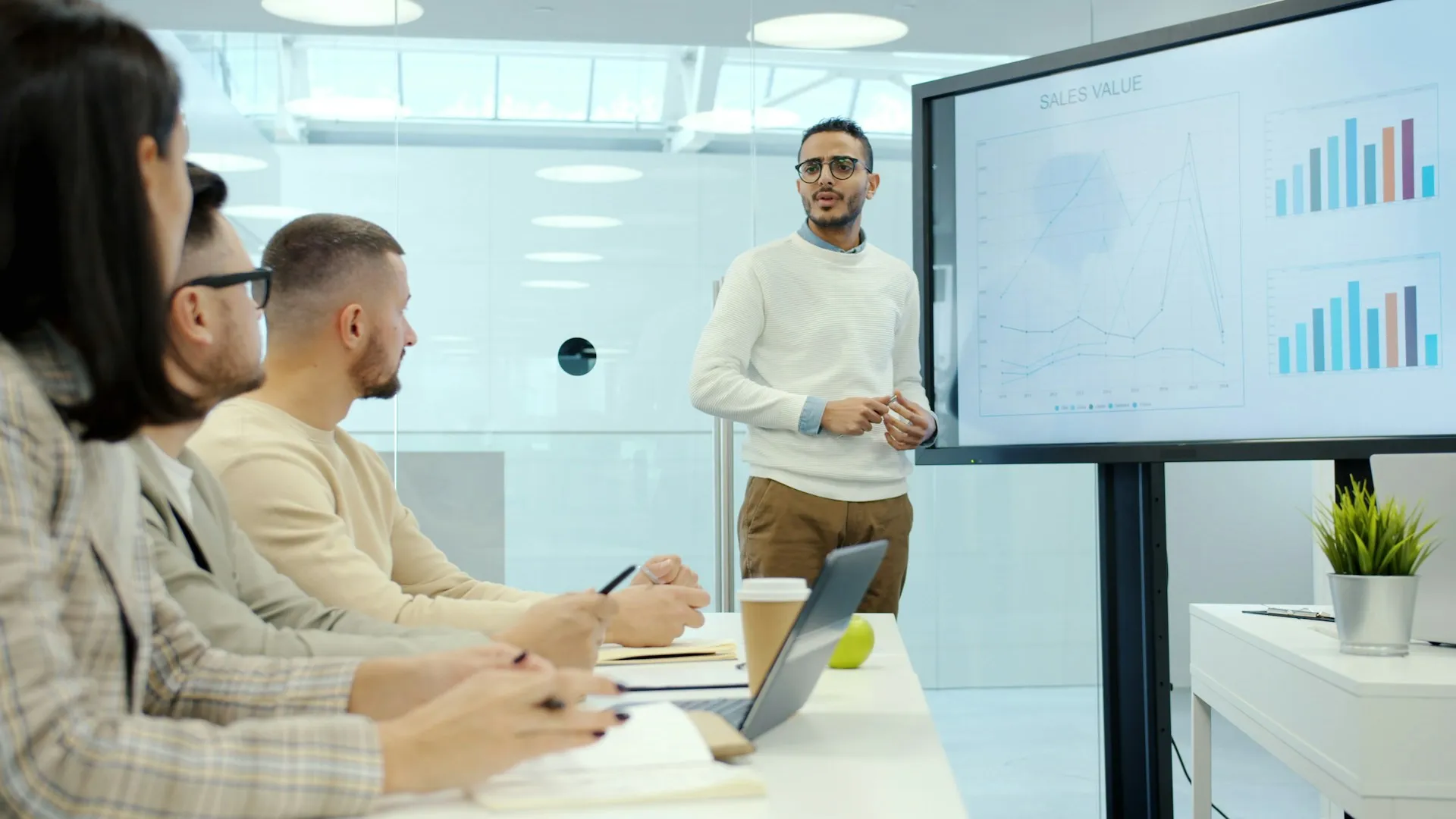 Sales team reviewing performance data during a presentation